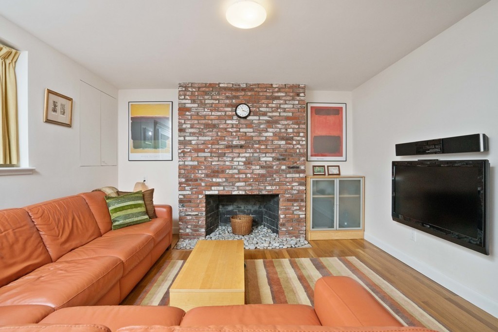 51 Baskin Road Lexington, MA 02421 - Photo 18 of 28 a living room with a couch and a fireplace