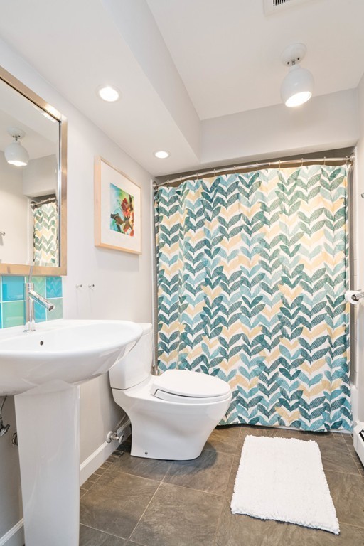 51 Baskin Road Lexington, MA 02421 - Photo 21 of 28 a bathroom with a sink toilet and window