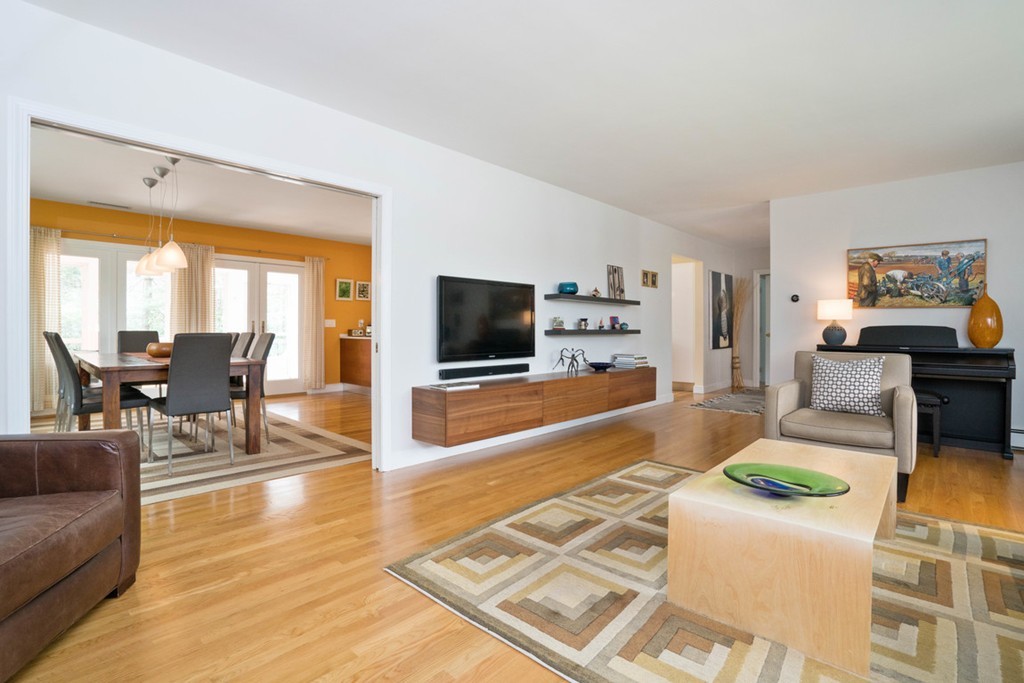 51 Baskin Road Lexington, MA 02421 - Photo 4 of 28 a living room with fireplace furniture and a flat screen tv