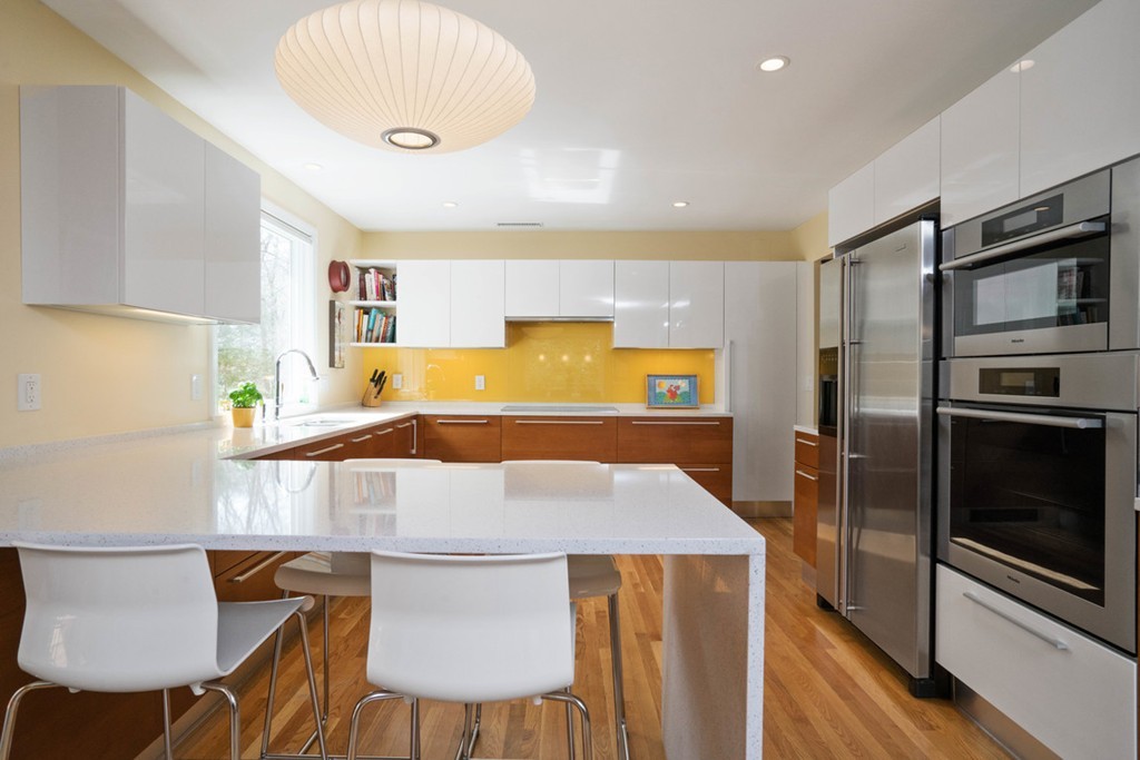 51 Baskin Road Lexington, MA 02421 - Photo 5 of 28 a kitchen with stainless steel appliances a stove a refrigerator and a dining table