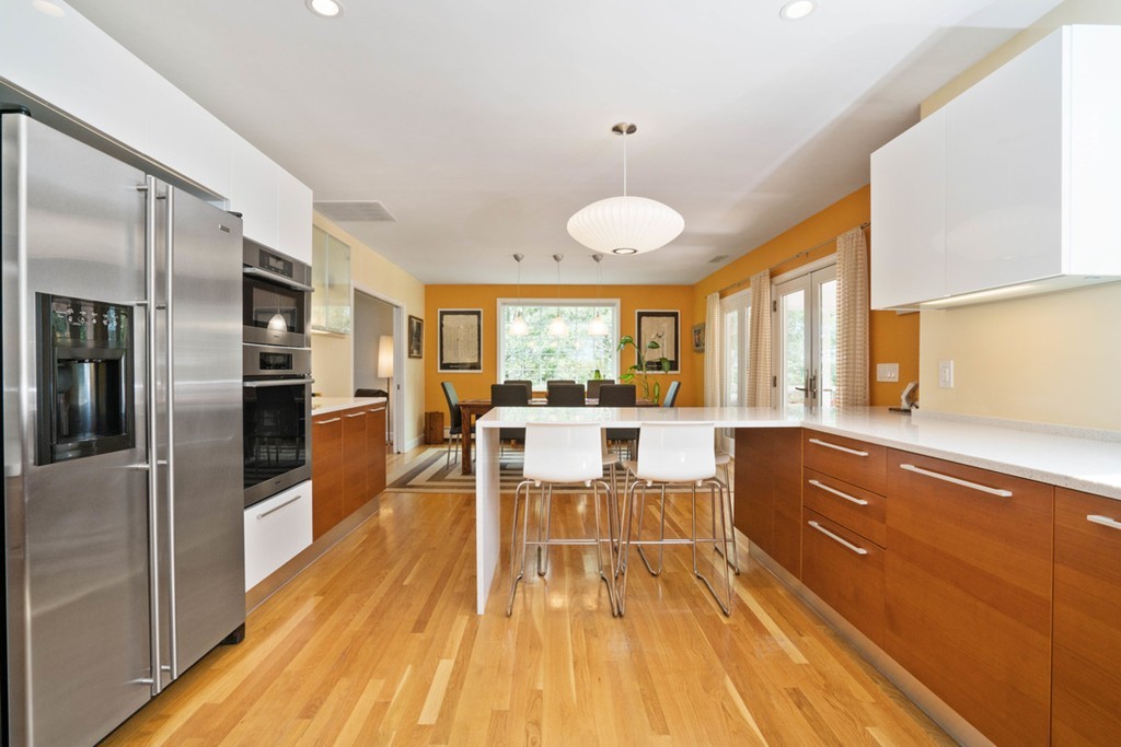 51 Baskin Road Lexington, MA 02421 - Photo 6 of 28 a kitchen with stainless steel appliances granite countertop a refrigerator a oven a stove and a sink with cabinets