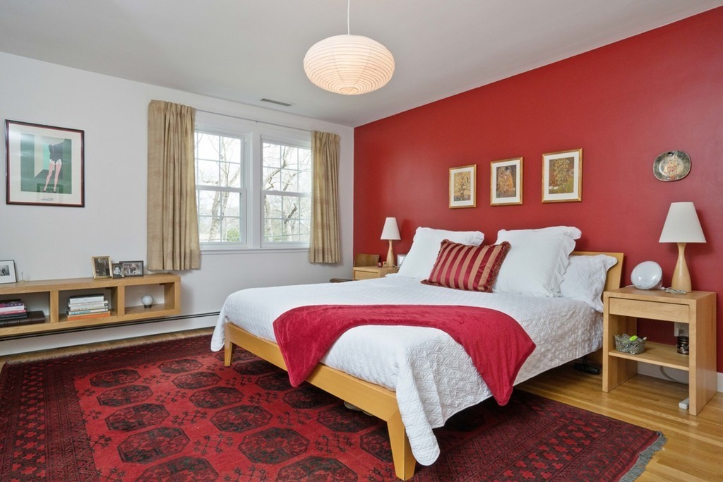 51 Baskin Road Lexington, MA 02421 - Photo 10 of 28 a bedroom with a bed and wooden floor