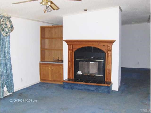 29 Charlie Winstead Road Roxboro, NC 27574 - Photo 3 of 4 a living room with a fireplace in it