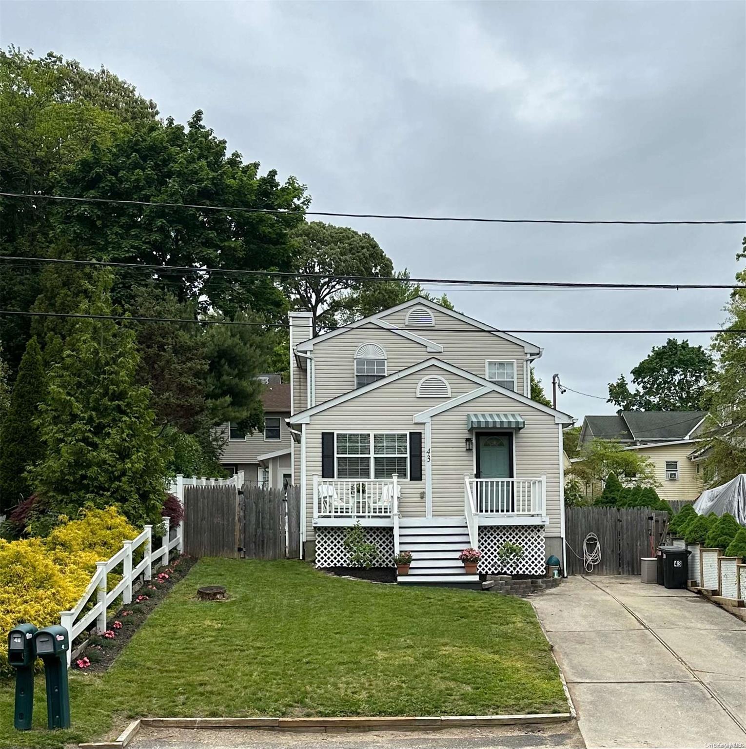 43 Comus Road Rocky Point, NY 11778 - Photo 1 of 1 a front view of a house with a yard