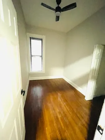 a view of a room with a wooden floor and a window