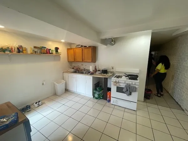 a kitchen with a sink a stove and cabinets