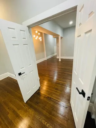 a view of a living room with furniture and wooden floor