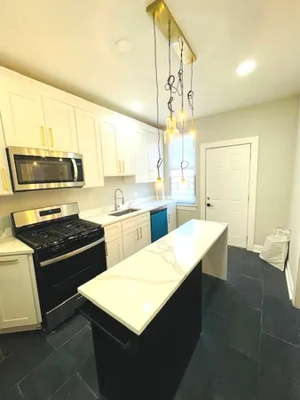 a kitchen with a stove a sink and a refrigerator