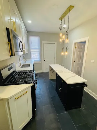 a kitchen with sink cabinets and wooden floor