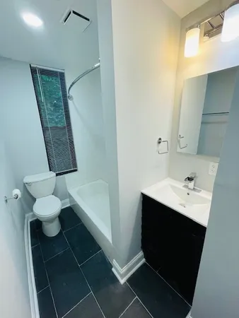 a bathroom with a sink toilet and mirror