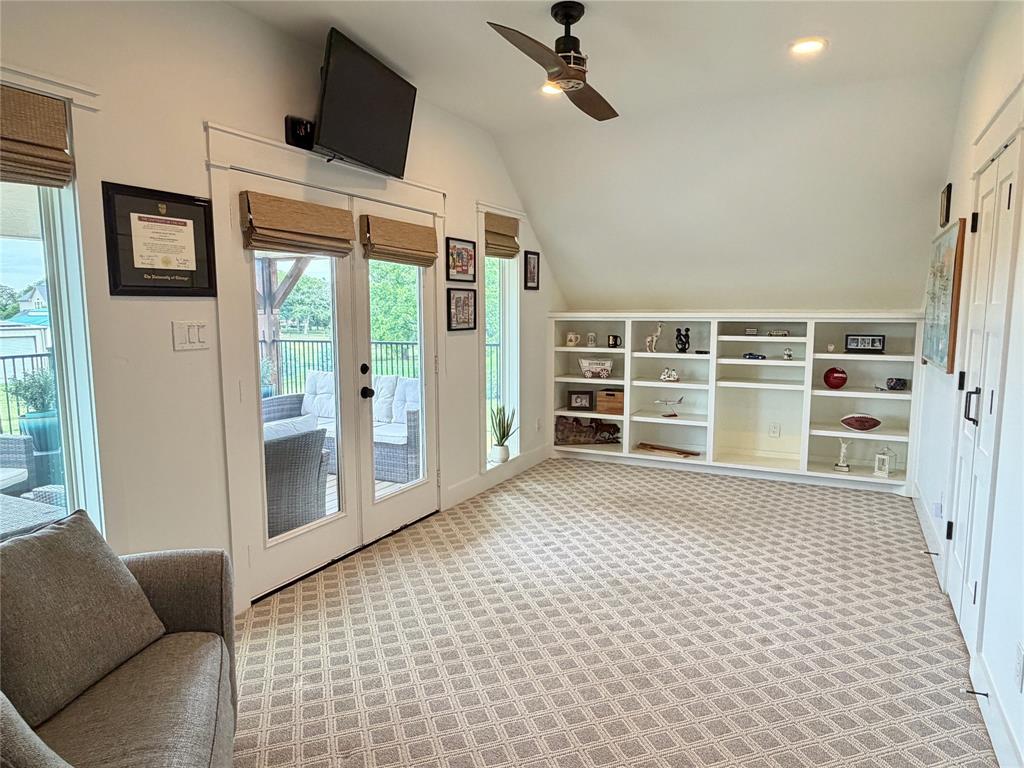 1304 Tinker Road Colleyville, TX 76034 - Photo 22 of 28 a living room with a couch and a flat screen tv