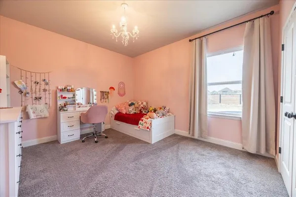 a bedroom with a bed and a chandelier