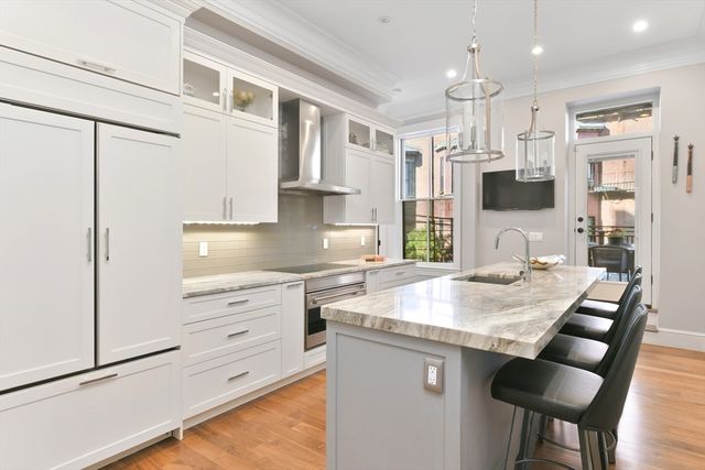 a kitchen with stainless steel appliances granite countertop a sink stove and refrigerator