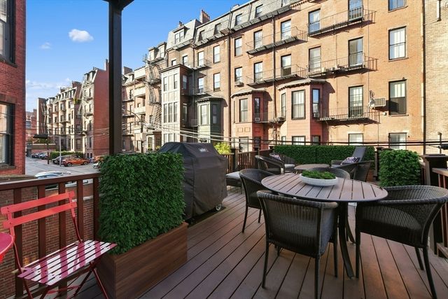 a view of a patio with a table and chairs