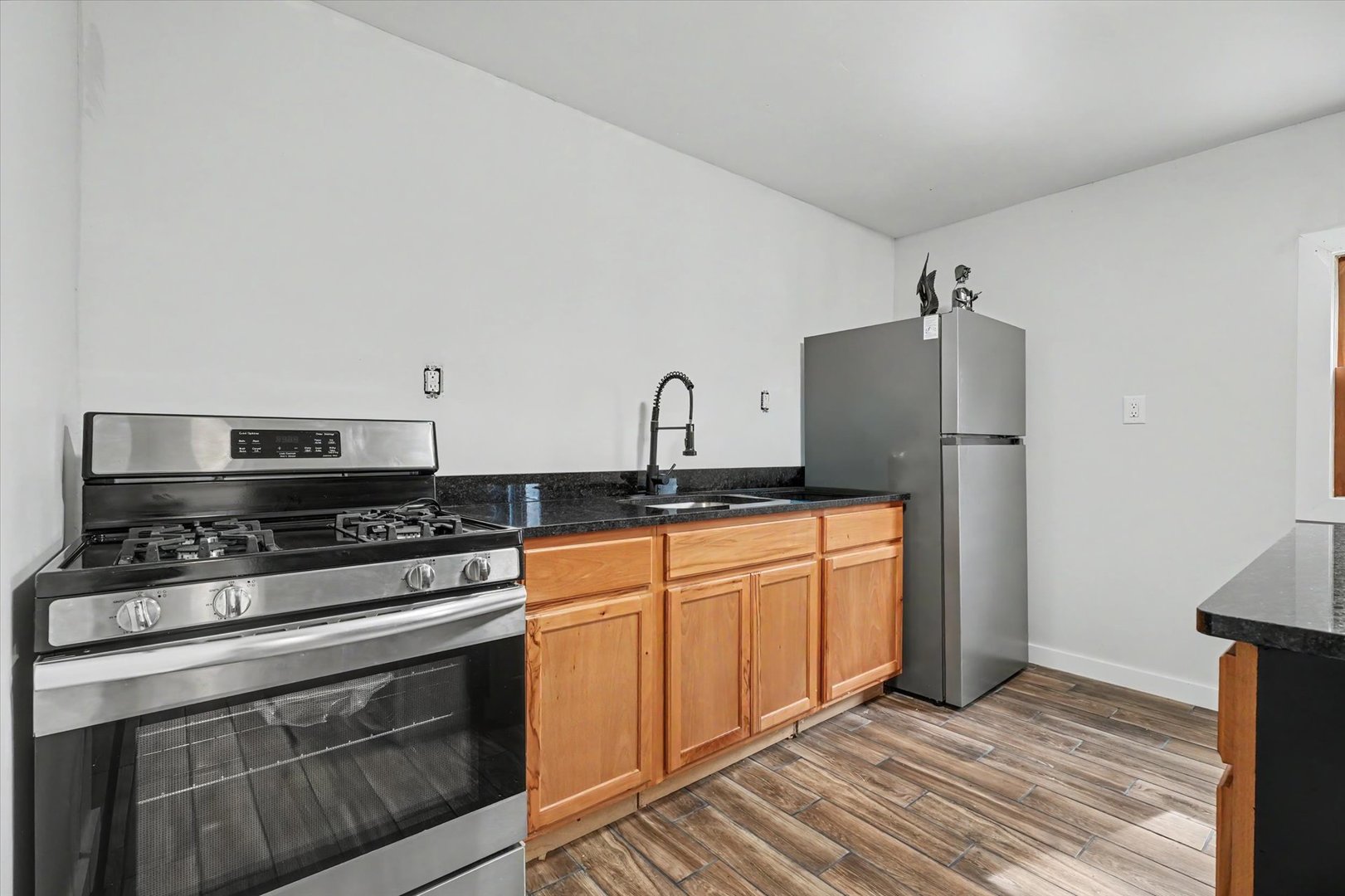 2431 North 1450 East Road Mansfield, IL 61854 - Photo 49 of 78 a kitchen with stainless steel appliances granite countertop a stove a sink and a refrigerator