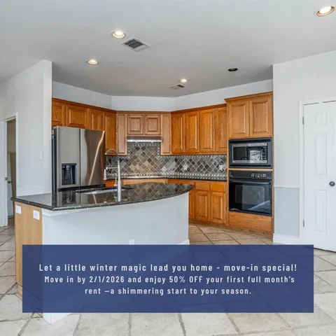 a view of kitchen with kitchen island granite countertop a stove top oven a sink and cabinets