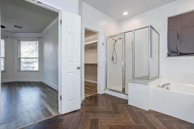 a spacious bathroom with a granite countertop sink a mirror and shower