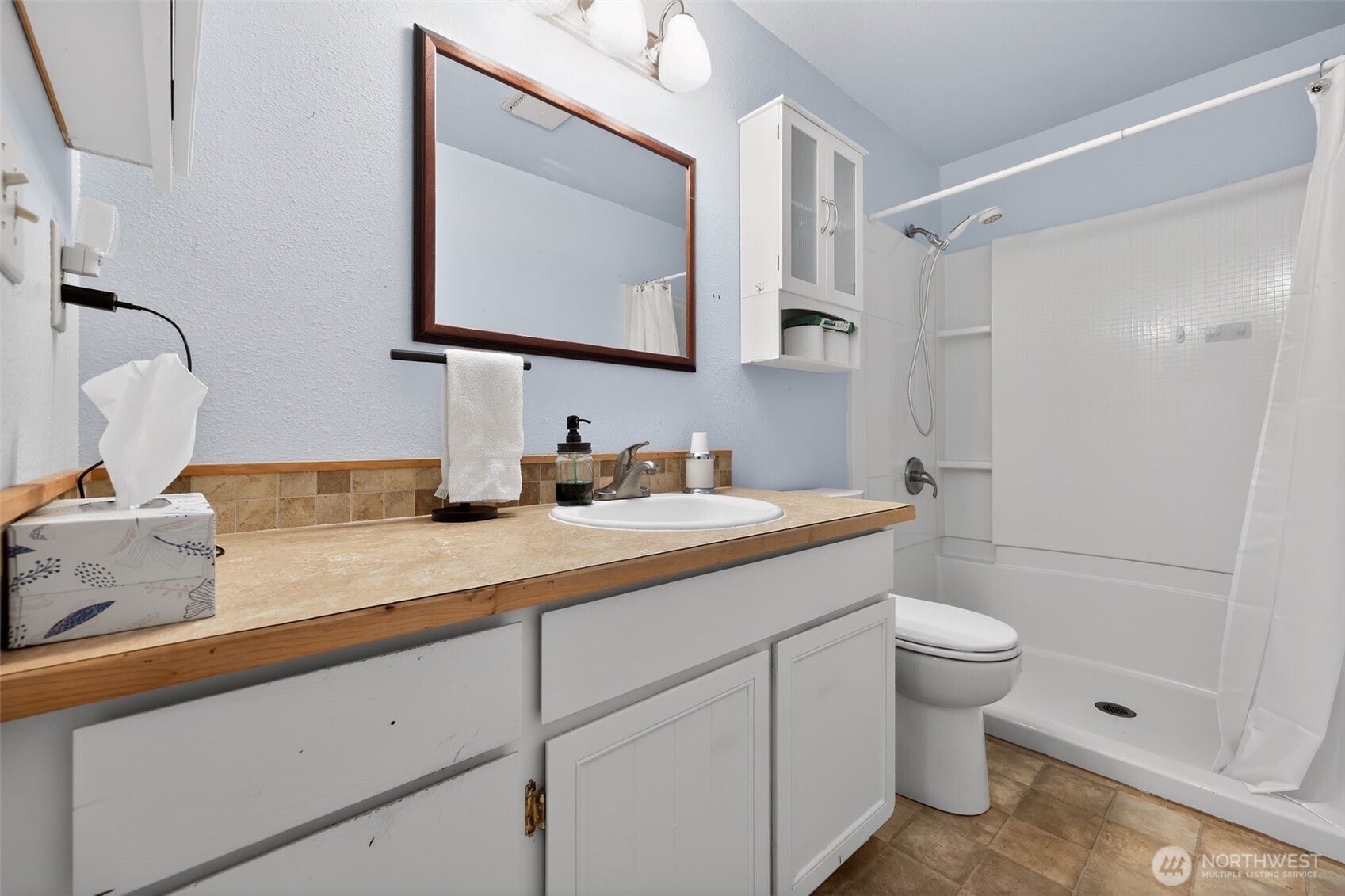 271 Hawkins Road Winlock, WA 98596 - Photo 14 of 26 a bathroom with a granite countertop sink a toilet and shower