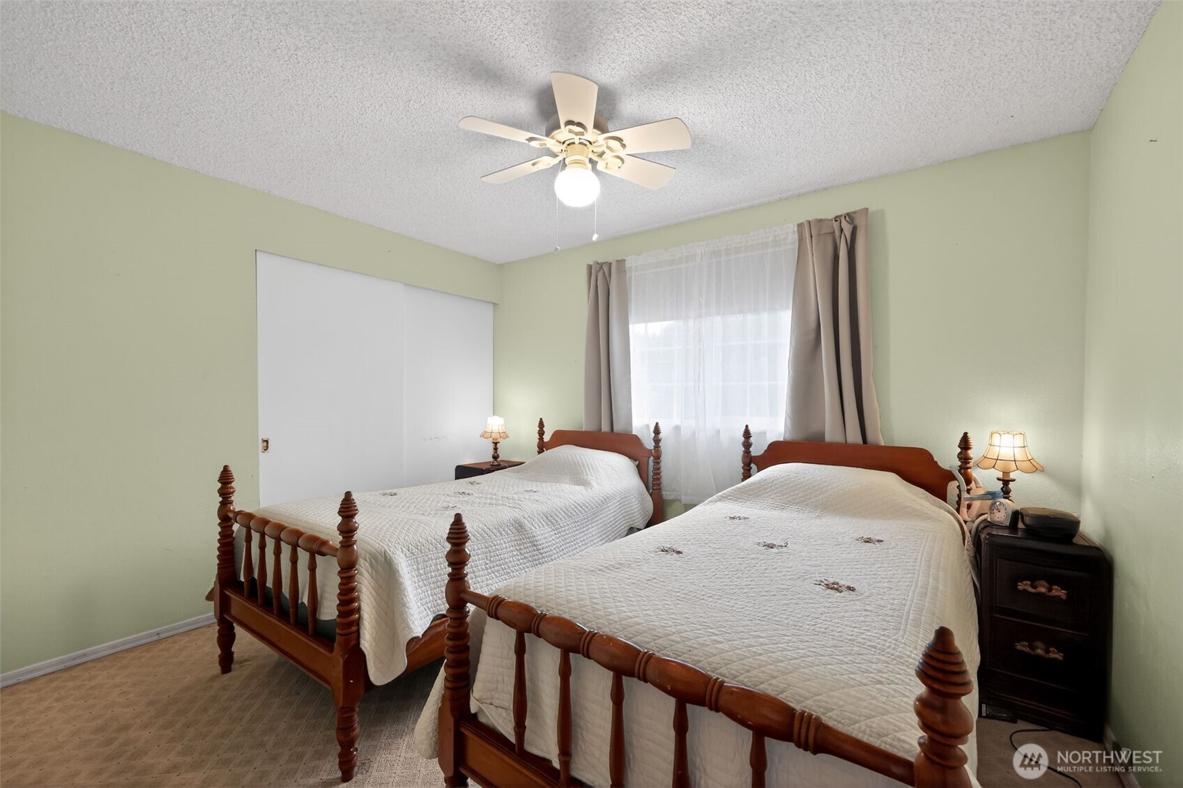 271 Hawkins Road Winlock, WA 98596 - Photo 15 of 26 a bedroom with two beds and a chandelier