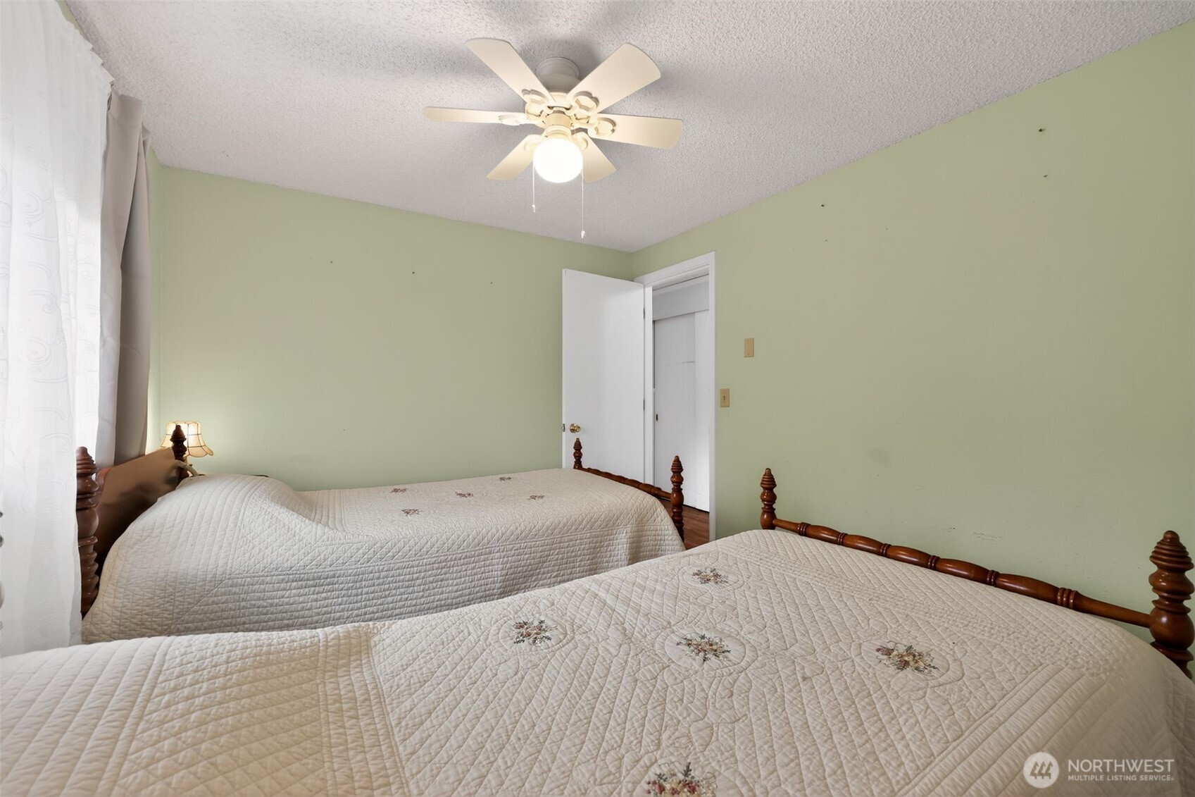 271 Hawkins Road Winlock, WA 98596 - Photo 16 of 26 a bedroom with a bed and a ceiling fan