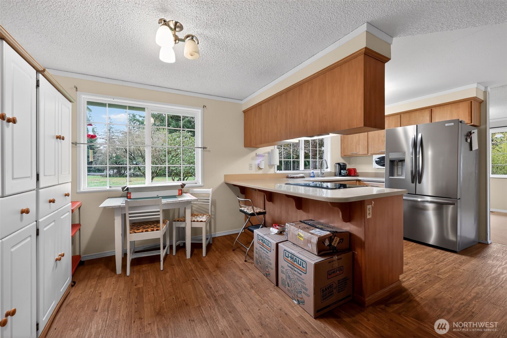 271 Hawkins Road Winlock, WA 98596 - Photo 7 of 26 a kitchen with stainless steel appliances granite countertop a table chairs stove and refrigerator