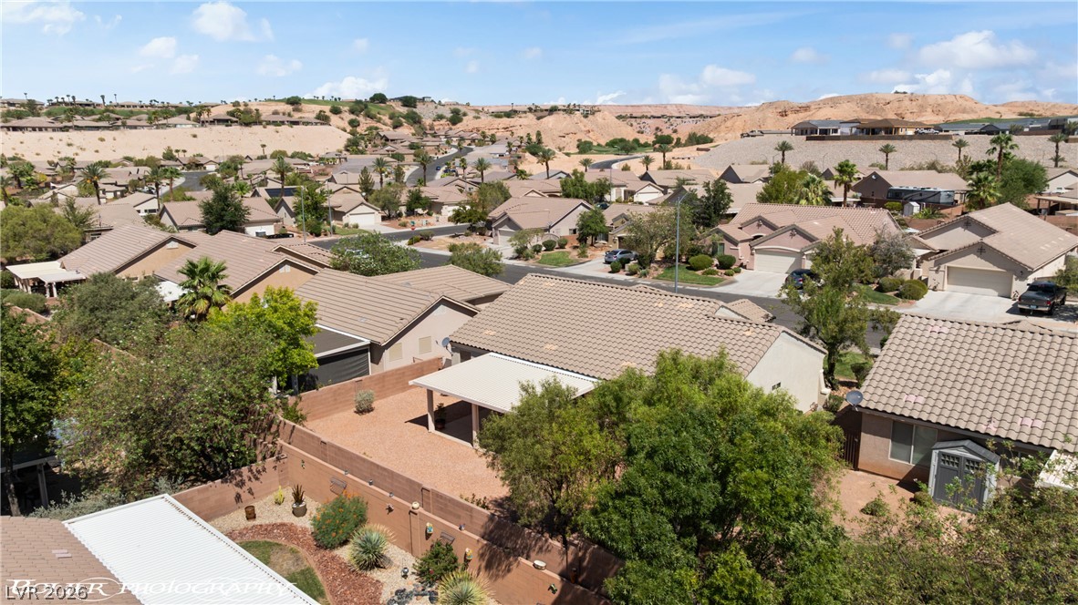 874 Glendale Road Mesquite, NV 89027 - Photo 66 of 71 An aerial perspective reveals a well-maintained neighborhood nestled among desert landscapes, showcasing tiled roofs and lush greenery.