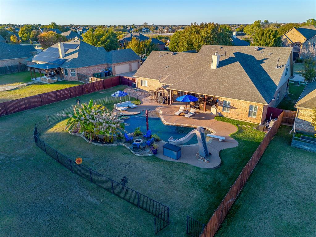 an aerial view of a house with a garden and pool