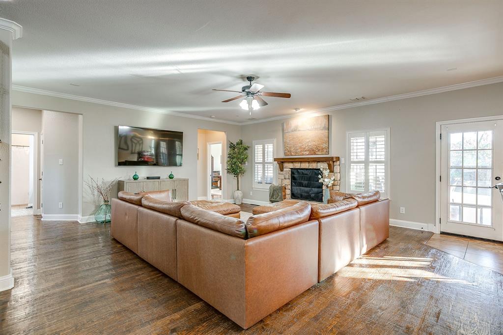 1249 Handkerchief Way Fort Worth, TX 76052 - Photo 11 of 40 a living room with furniture a fireplace and a flat screen tv