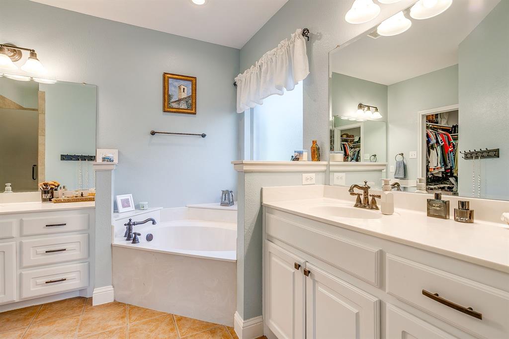 1249 Handkerchief Way Fort Worth, TX 76052 - Photo 18 of 40 a bathroom with a tub sink double vanity and mirror