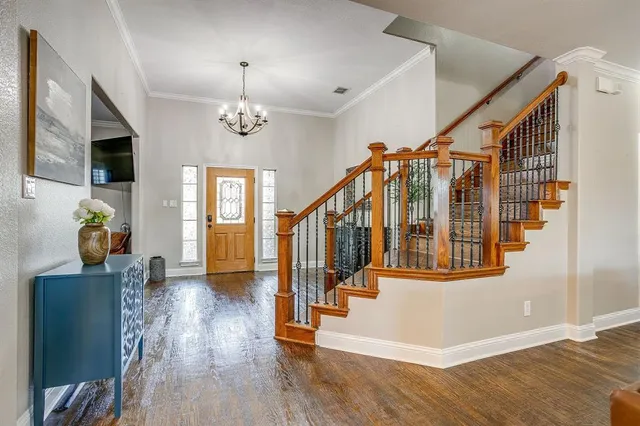 a view of an entryway with wooden floor and stairs