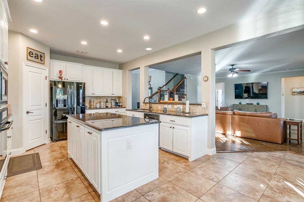1249 Handkerchief Way Fort Worth, TX 76052 - Photo 30 of 40 a kitchen with granite countertop a sink stove and refrigerator