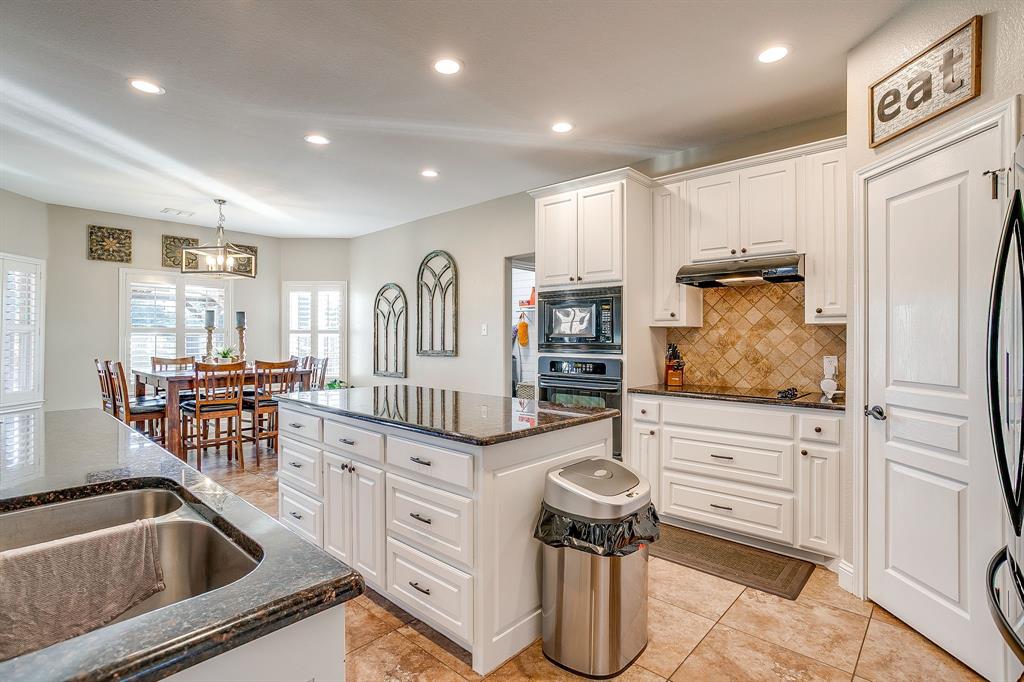 1249 Handkerchief Way Fort Worth, TX 76052 - Photo 5 of 40 a kitchen with stainless steel appliances granite countertop a sink and a refrigerator