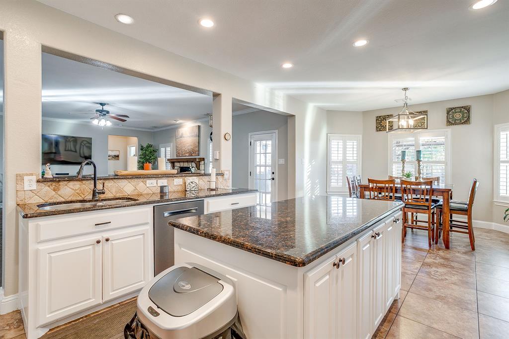 1249 Handkerchief Way Fort Worth, TX 76052 - Photo 6 of 40 a dining hall with stainless steel appliances granite countertop a sink a stove a dining table and chairs