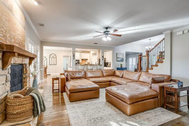a living room with furniture ceiling fan and a fireplace