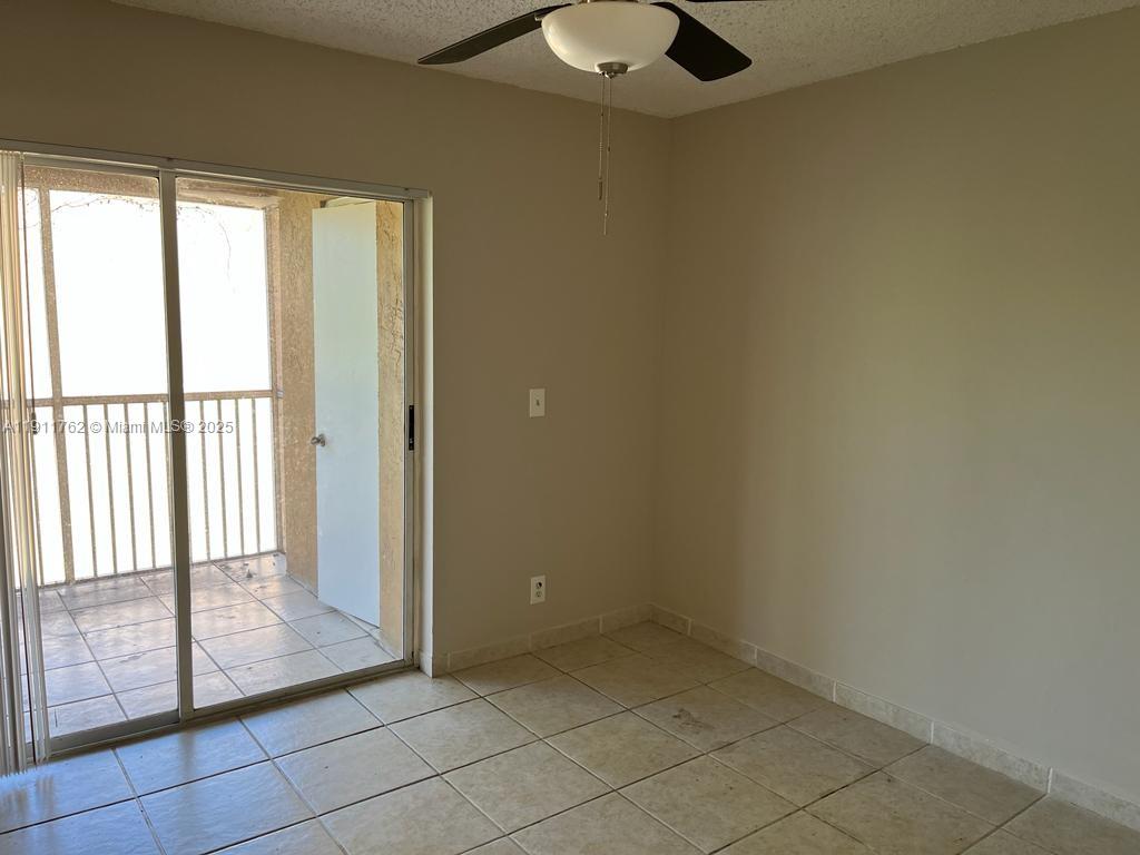 4015 West McNab Road, Unit D308 Pompano Beach, FL 33069 - Photo 4 of 17 an empty room with windows