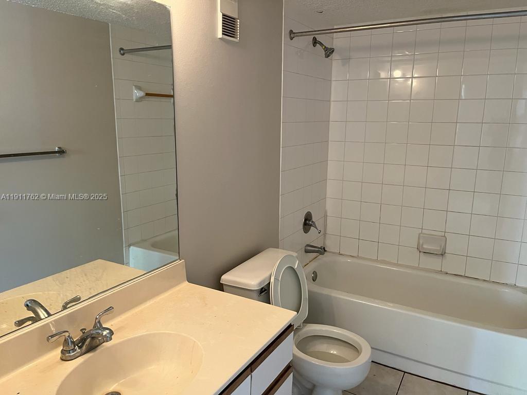 4015 West McNab Road, Unit D308 Pompano Beach, FL 33069 - Photo 6 of 17 a bathroom with a sink toilet and shower