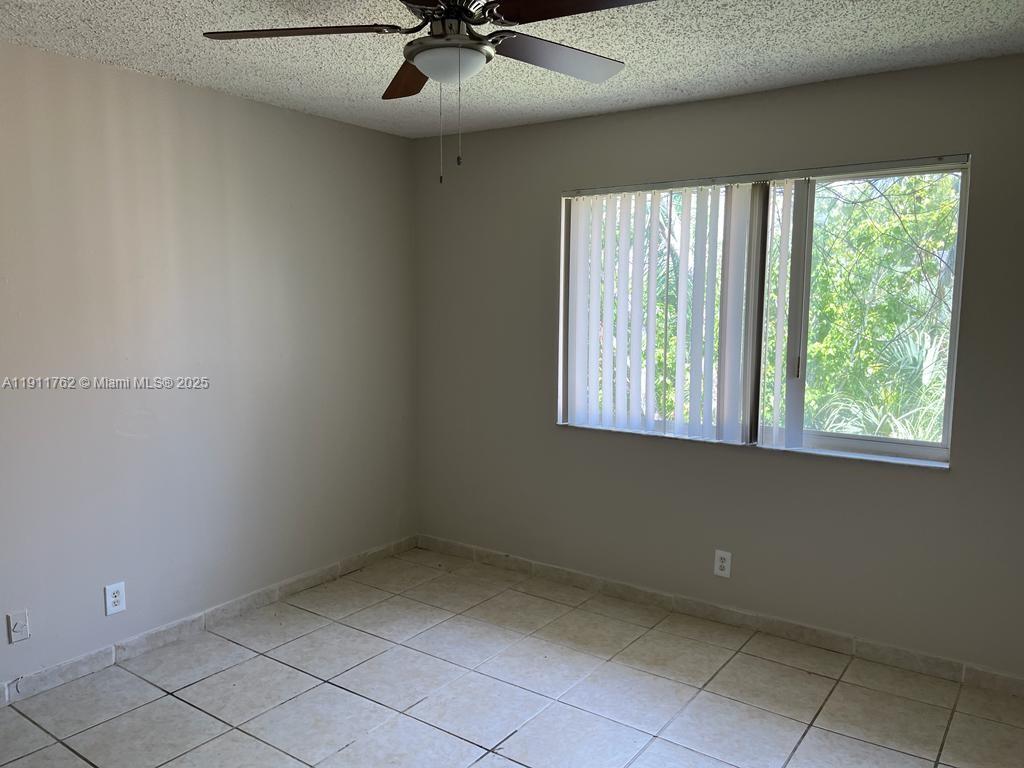 4015 West McNab Road, Unit D308 Pompano Beach, FL 33069 - Photo 7 of 17 a view of an empty room with a window