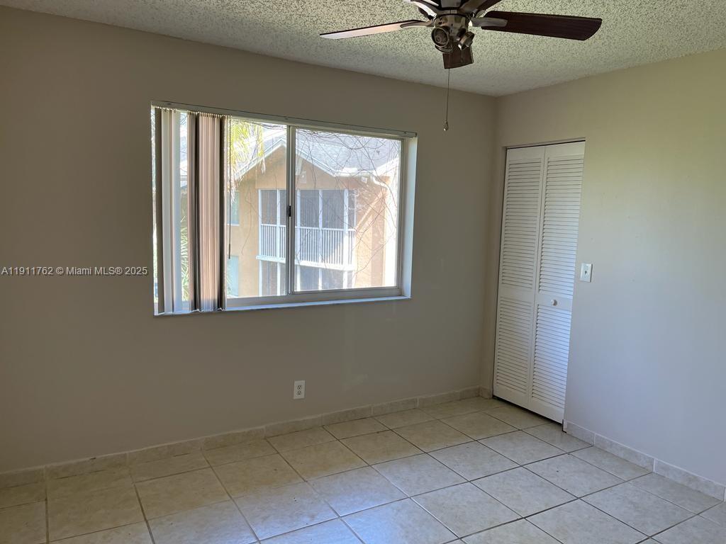 4015 West McNab Road, Unit D308 Pompano Beach, FL 33069 - Photo 8 of 17 an empty room with a window