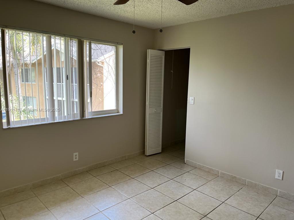 4015 West McNab Road, Unit D308 Pompano Beach, FL 33069 - Photo 9 of 17 an empty room with windows