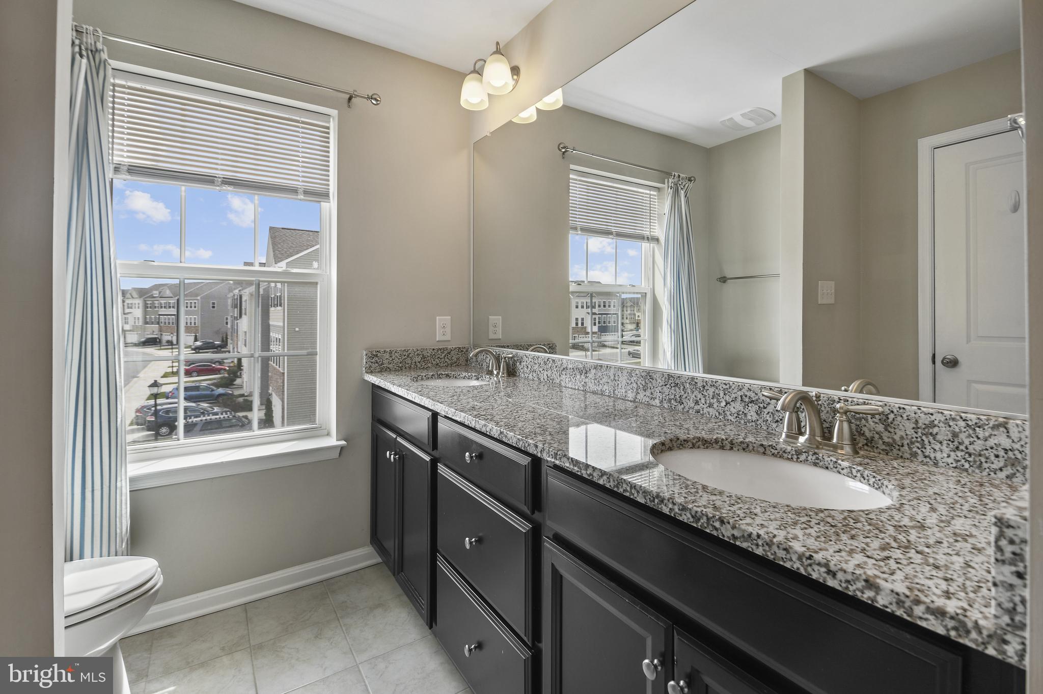 4648 Cambria Road Frederick, MD 21703 - Photo 13 of 22 a bathroom with a granite countertop sink and a mirror