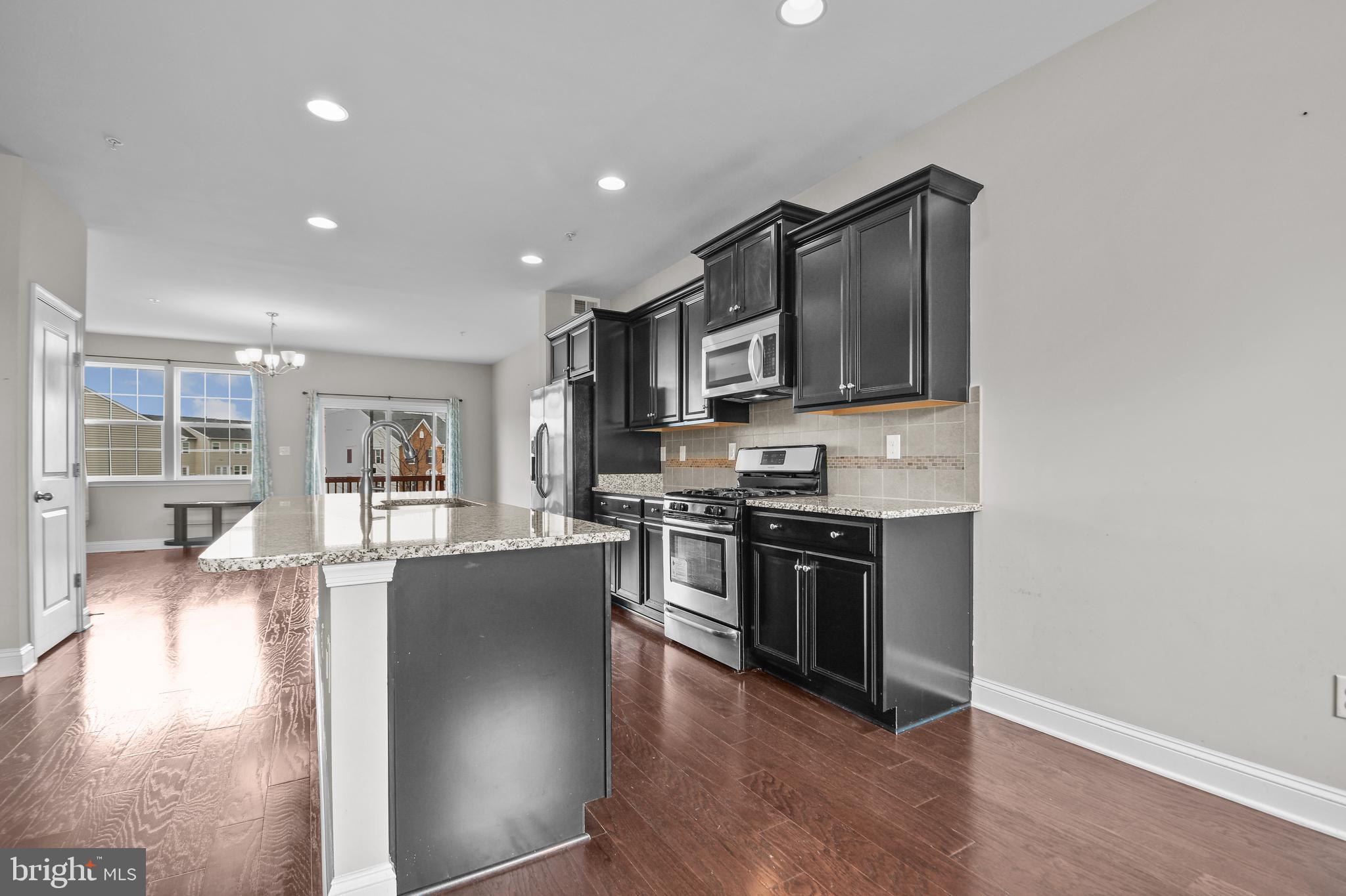4648 Cambria Road Frederick, MD 21703 - Photo 4 of 22 a kitchen with stainless steel appliances granite countertop a stove a sink and a refrigerator