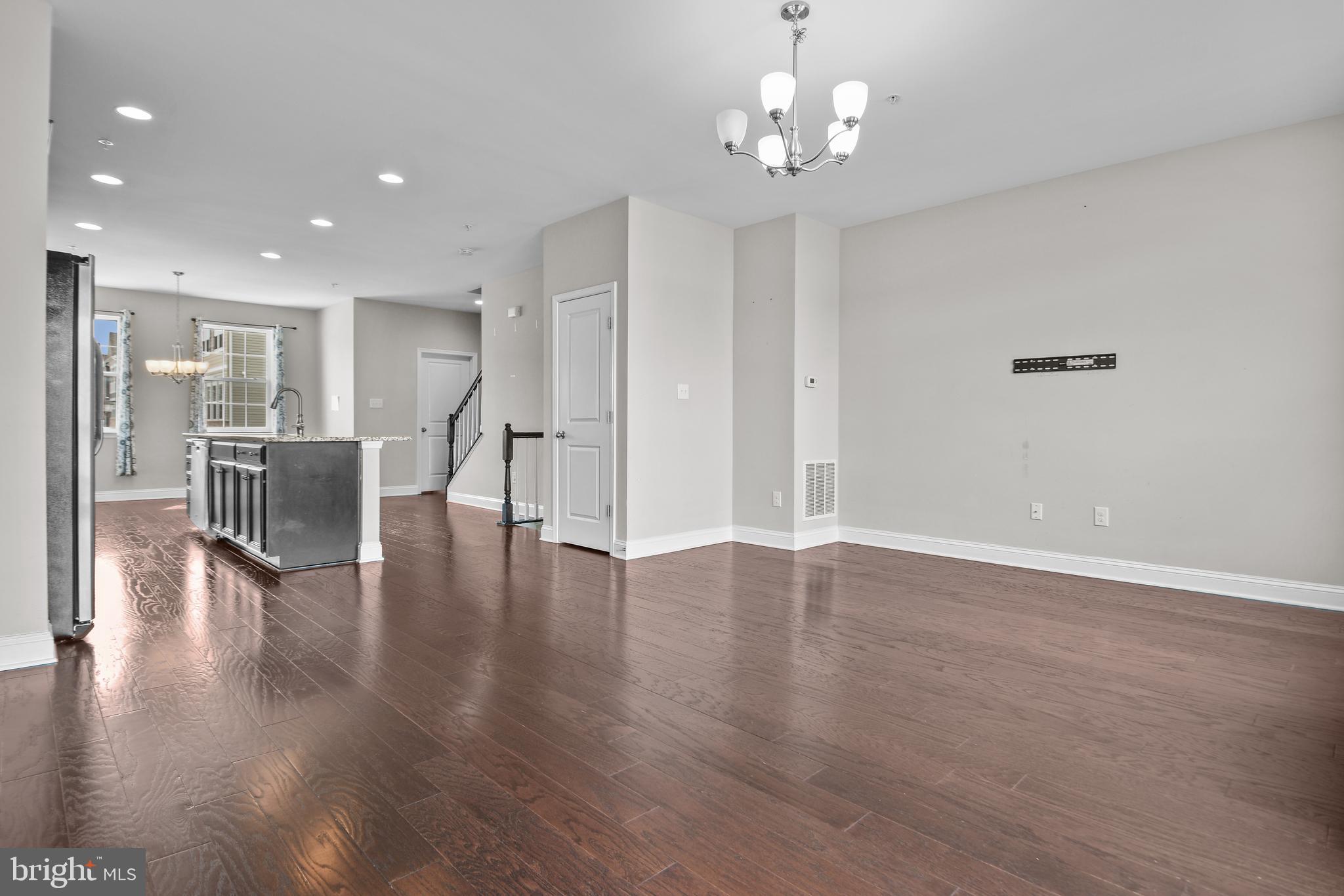 4648 Cambria Road Frederick, MD 21703 - Photo 5 of 22 a view of a livingroom with furniture wooden floor windows and a chandelier
