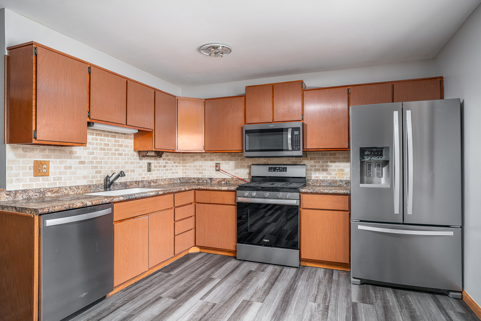4905 50th Street Moline, IL 61265 - Photo 11 of 25 a kitchen with stainless steel appliances a refrigerator stove microwave and sink