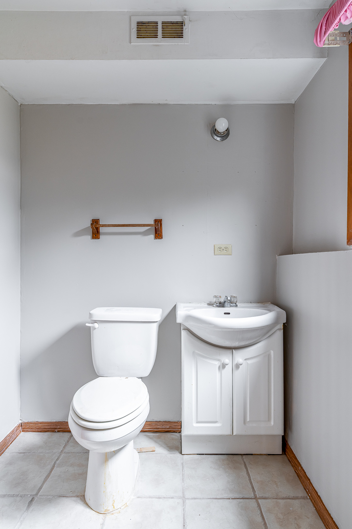 4905 50th Street Moline, IL 61265 - Photo 24 of 25 a bathroom with a sink a toilet and a shower