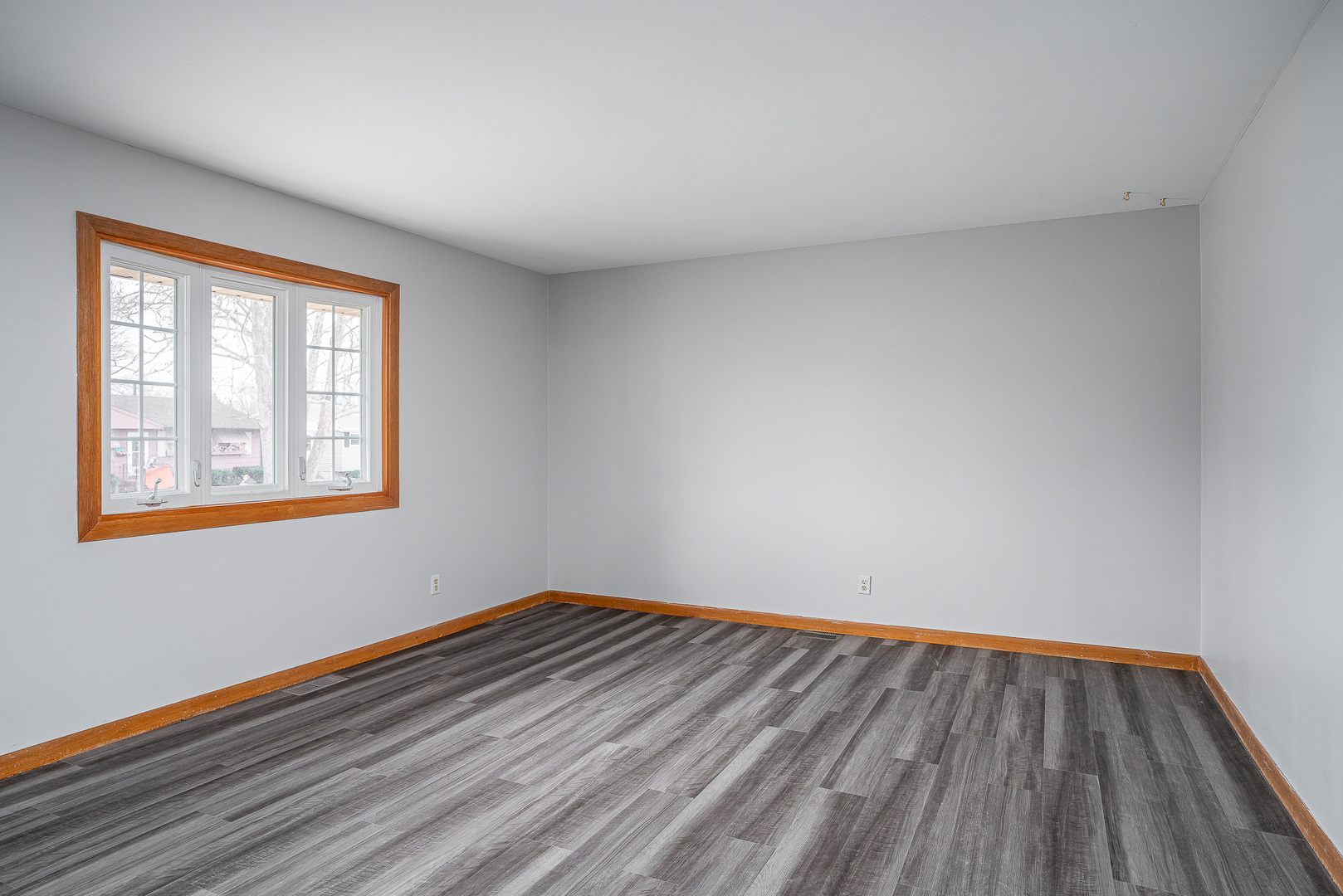 4905 50th Street Moline, IL 61265 - Photo 8 of 25 a view of a room with wooden floor and windows