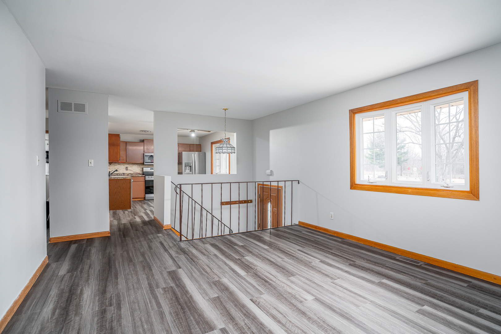 4905 50th Street Moline, IL 61265 - Photo 9 of 25 a view of empty room with wooden floor and fan