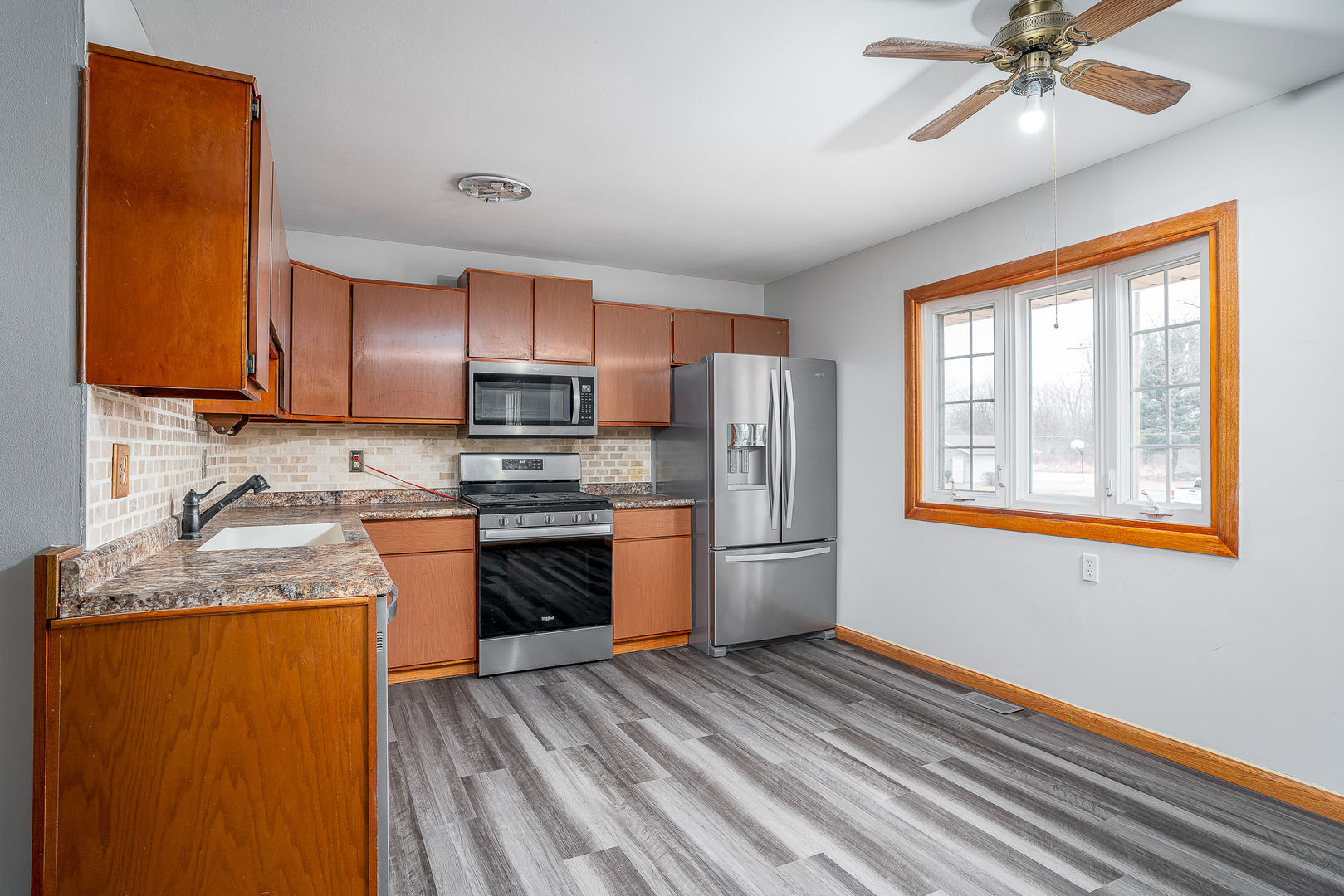 4905 50th Street Moline, IL 61265 - Photo 10 of 25 a kitchen with stainless steel appliances granite countertop a refrigerator sink and stove