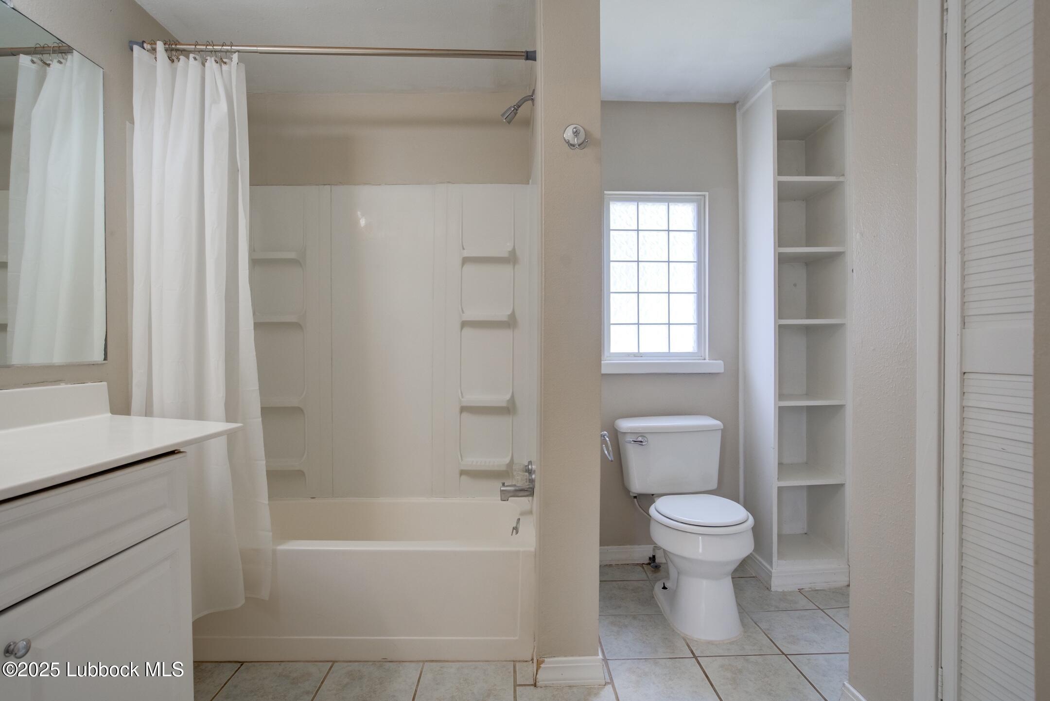 2308 28th Street Lubbock, TX 79411 - Photo 11 of 21 a bathroom with a bathtub toilet and sink