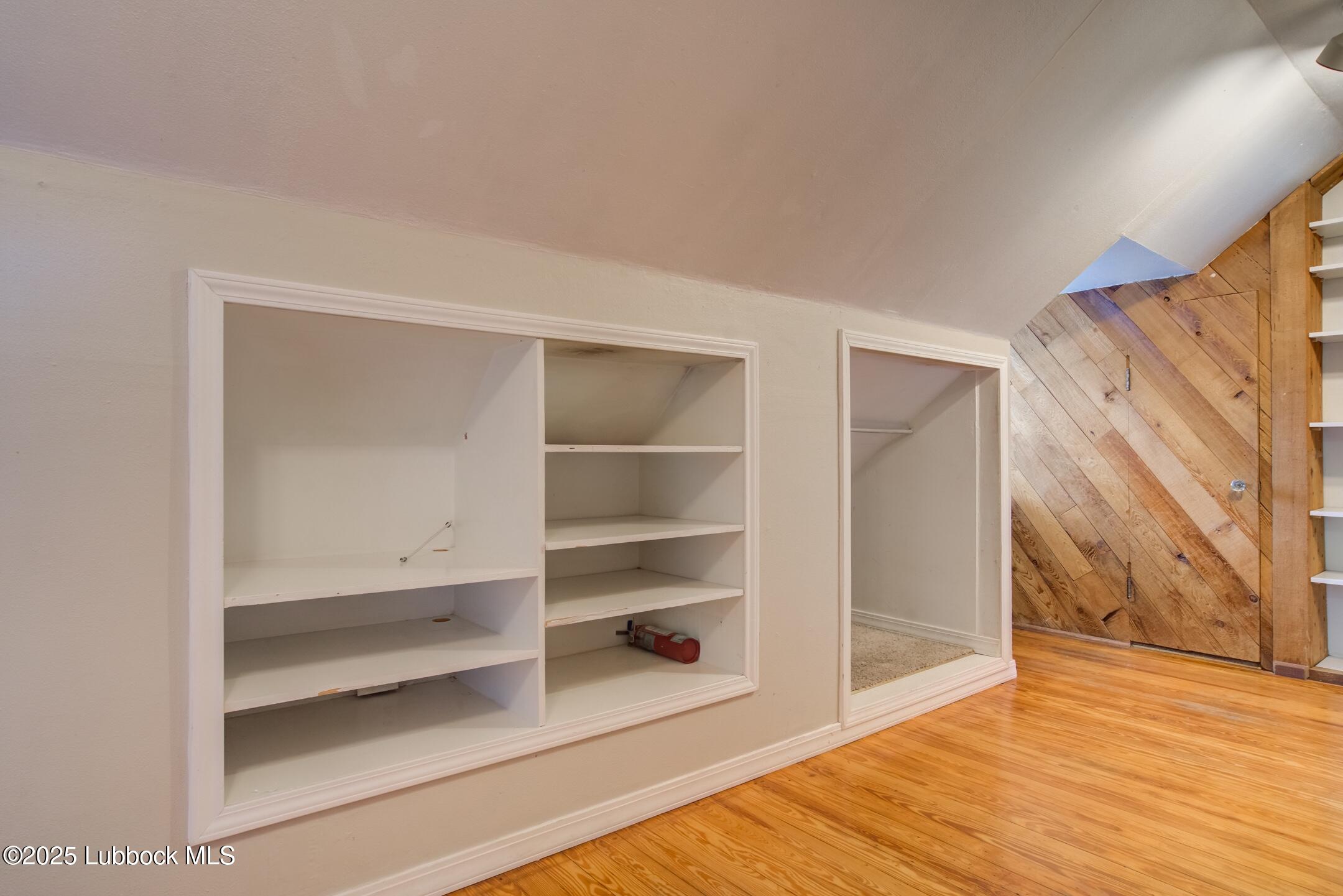 2308 28th Street Lubbock, TX 79411 - Photo 18 of 21 a view of an empty room with wooden floor and a window