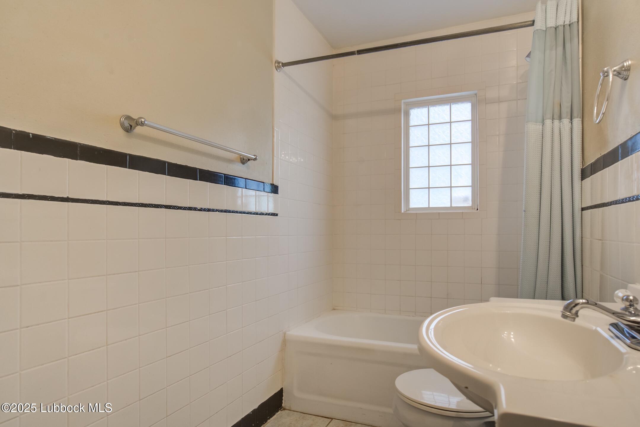 2308 28th Street Lubbock, TX 79411 - Photo 20 of 21 a bathroom with a sink a toilet and shower